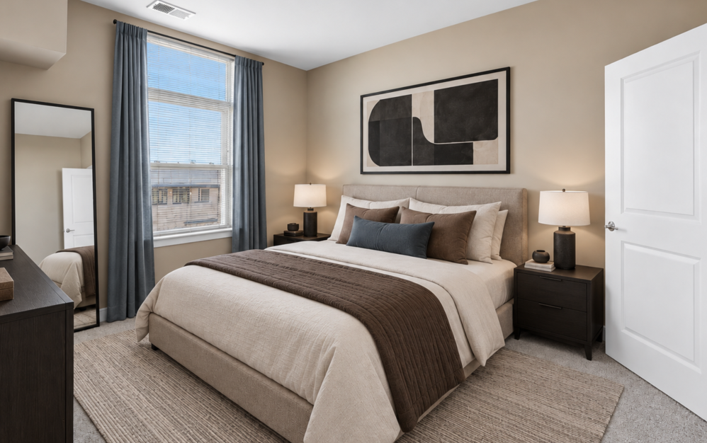 Bright two-bedroom apartment interior featuring a furnished bedroom, large window, and contemporary decor at The Swift at Petworth.