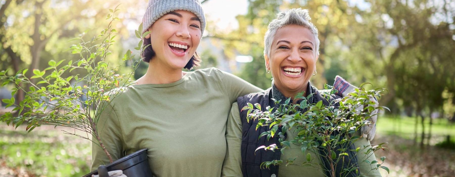 a couple of women holding plants