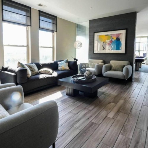 a clubroom with a couch, chairs and a coffee table