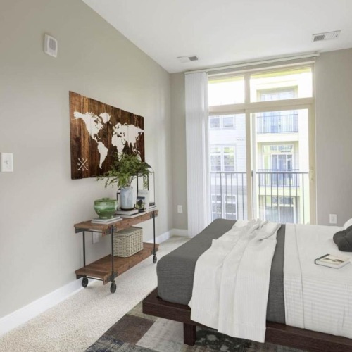 a bedroom with a bed and a table