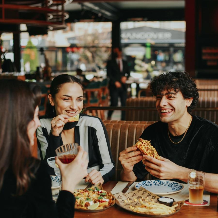 a group of people eating pizza