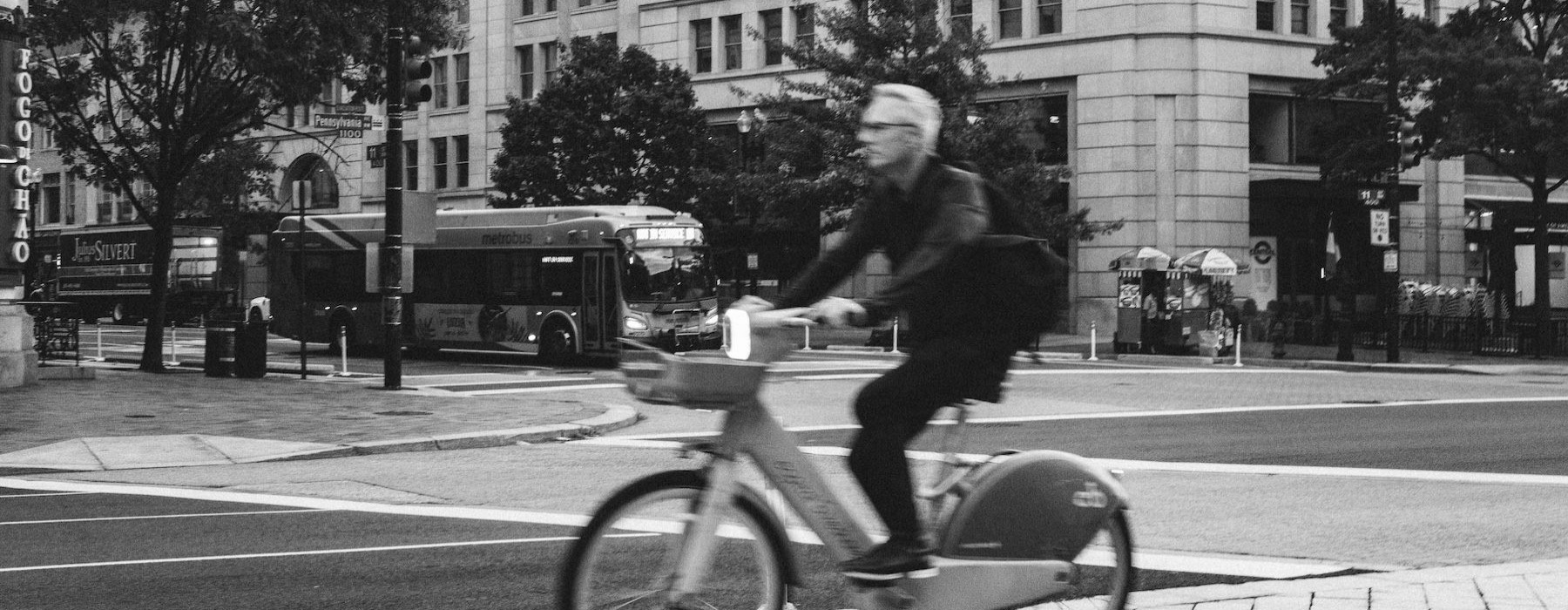 a man riding a bike in a city