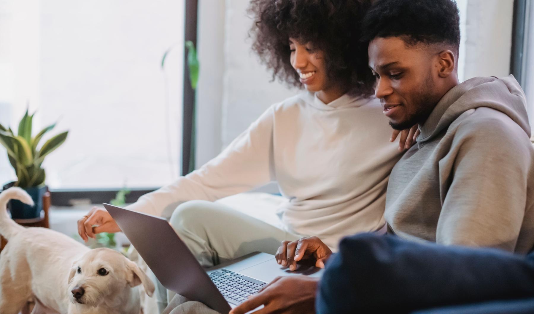 a man and a woman looking at a laptop