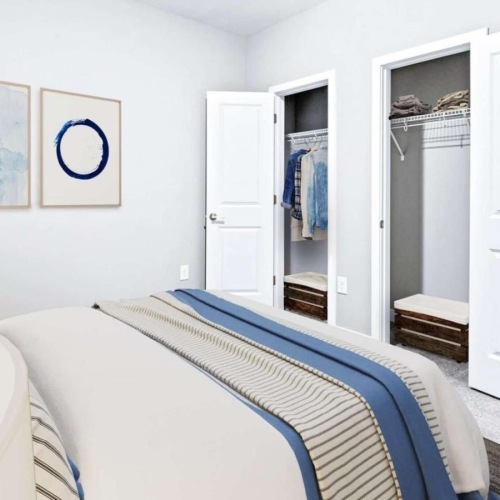 a bedroom with a bed and closets