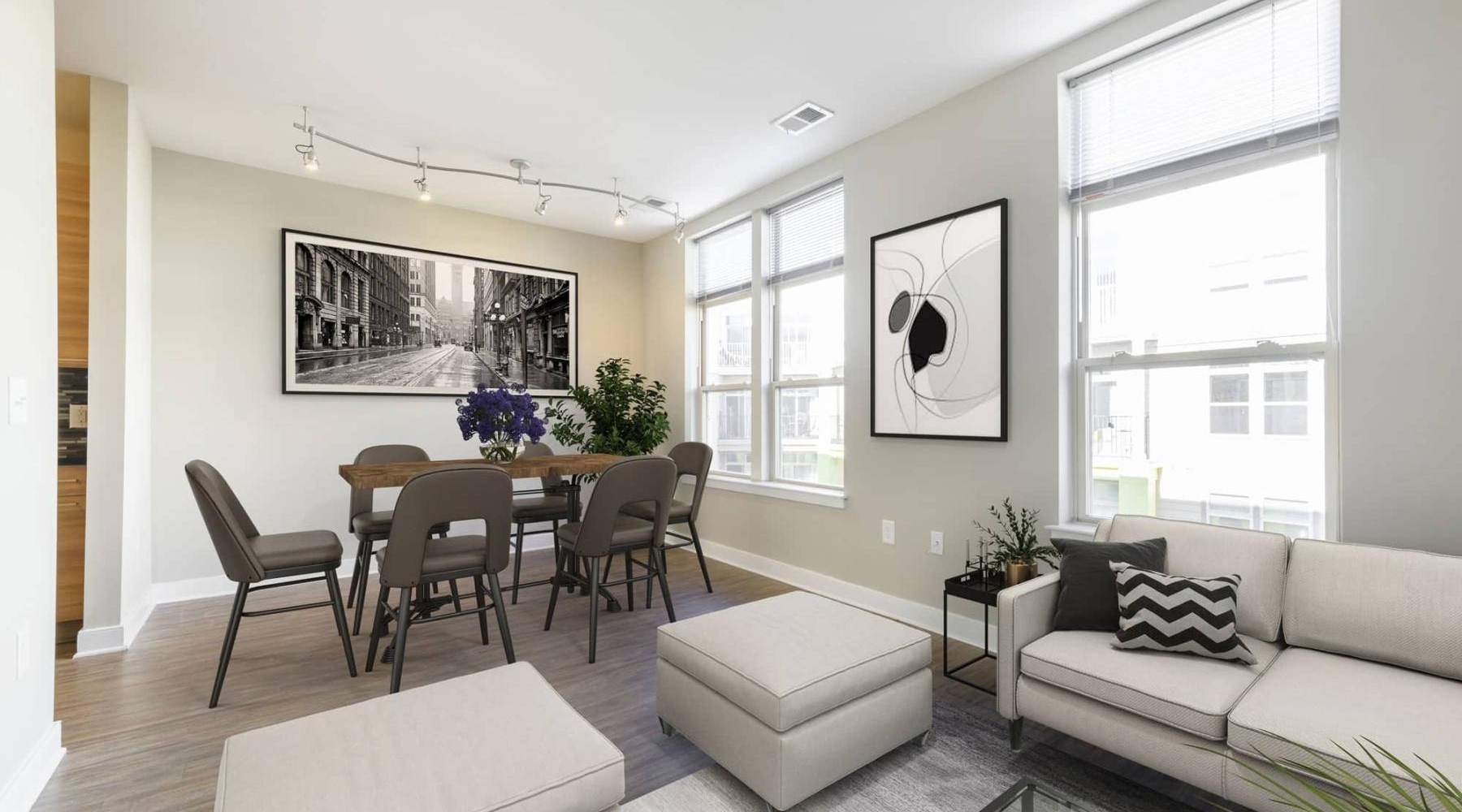 a living room with a couch, dining table and chairs