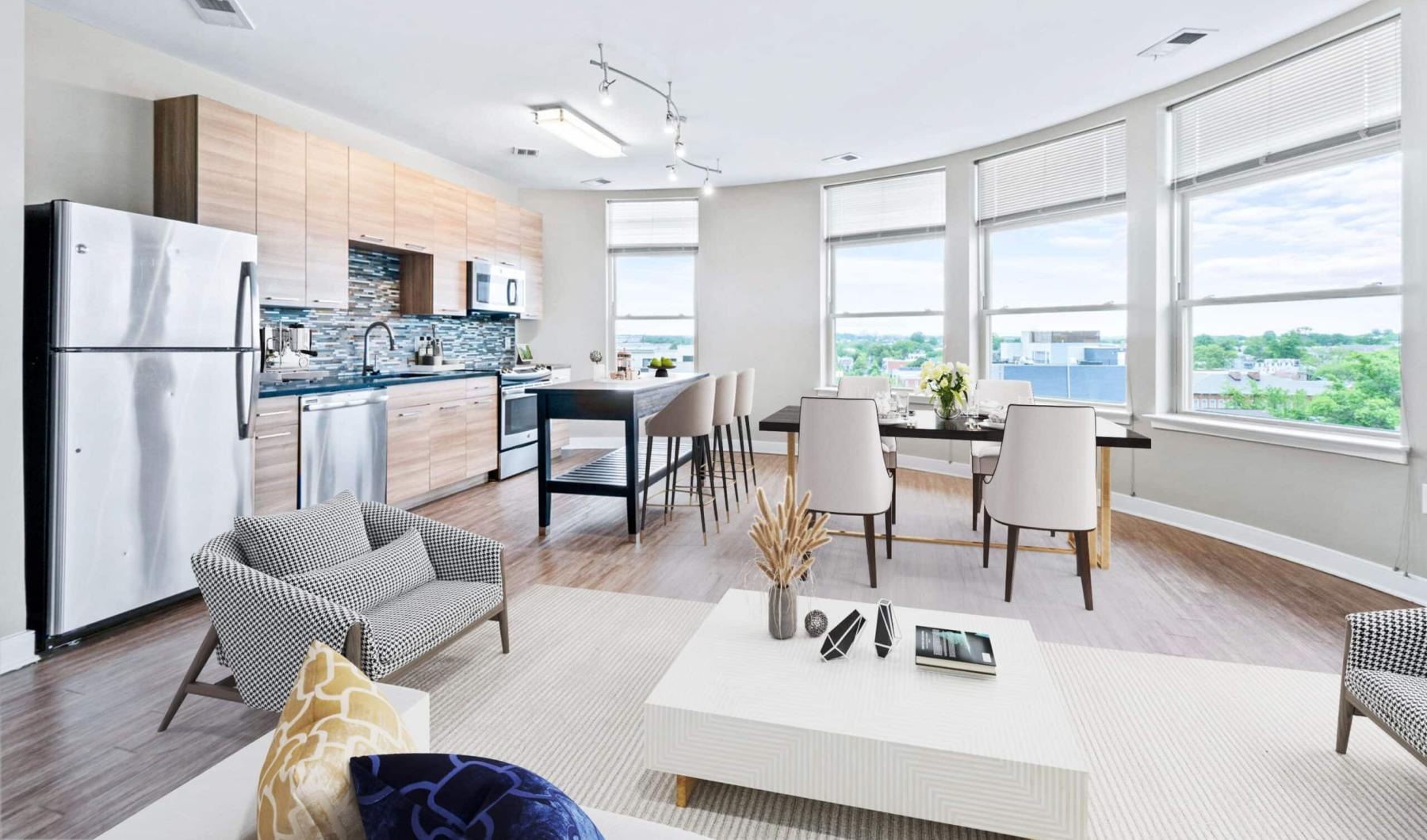 a kitchen and living room with tables and chairs